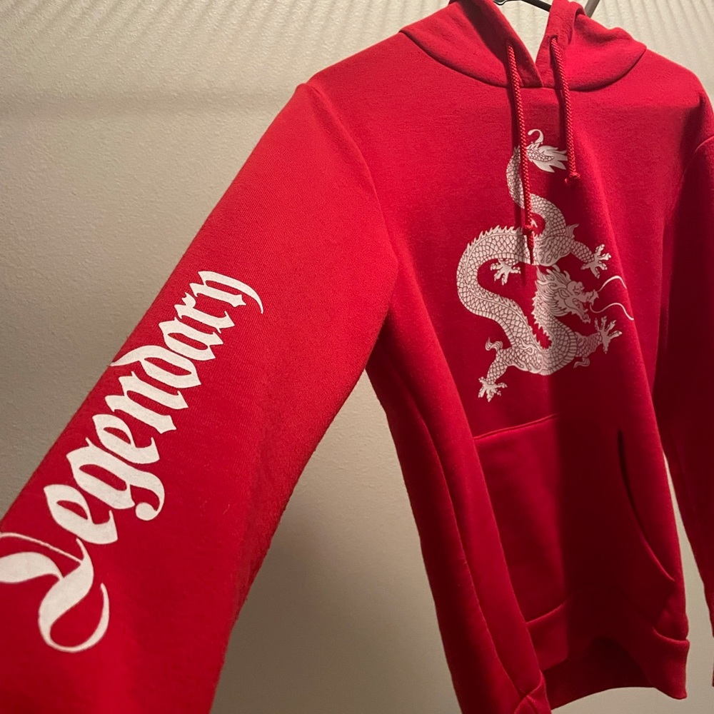 Soft, red hoodie. With dragon and legendary slogan on arms